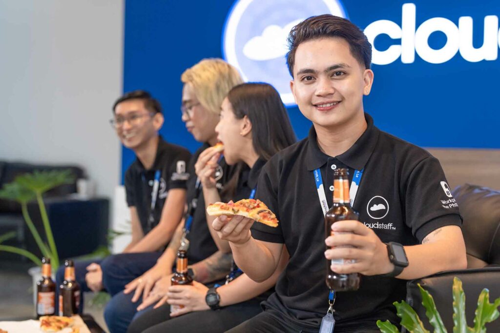 A Cloudstaffer and his colleagues with pizza and beer