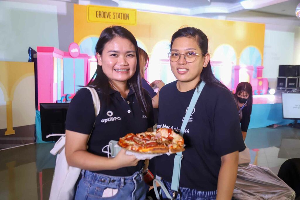 Two female Cloudstaffers holding a pizza