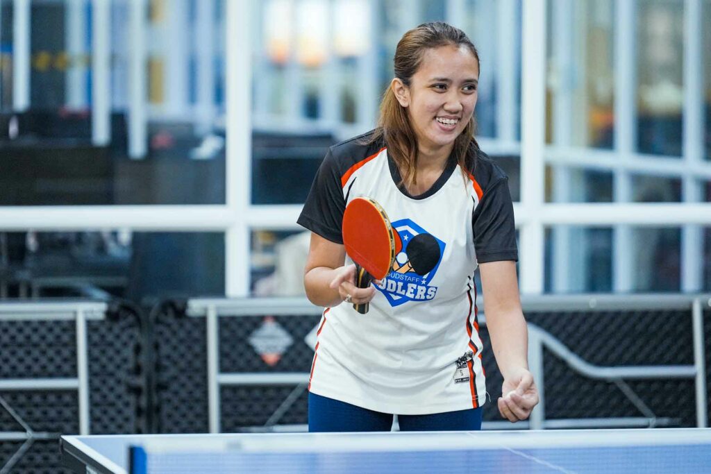 A female Cloudstaffer about to serve the ball in a ping pong game